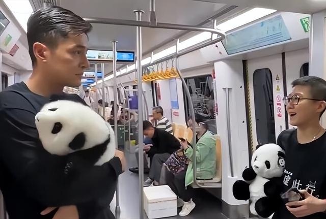 胡歌抱国宝现身地铁（和剧组人员抱着熊猫玩具乘车）(5)